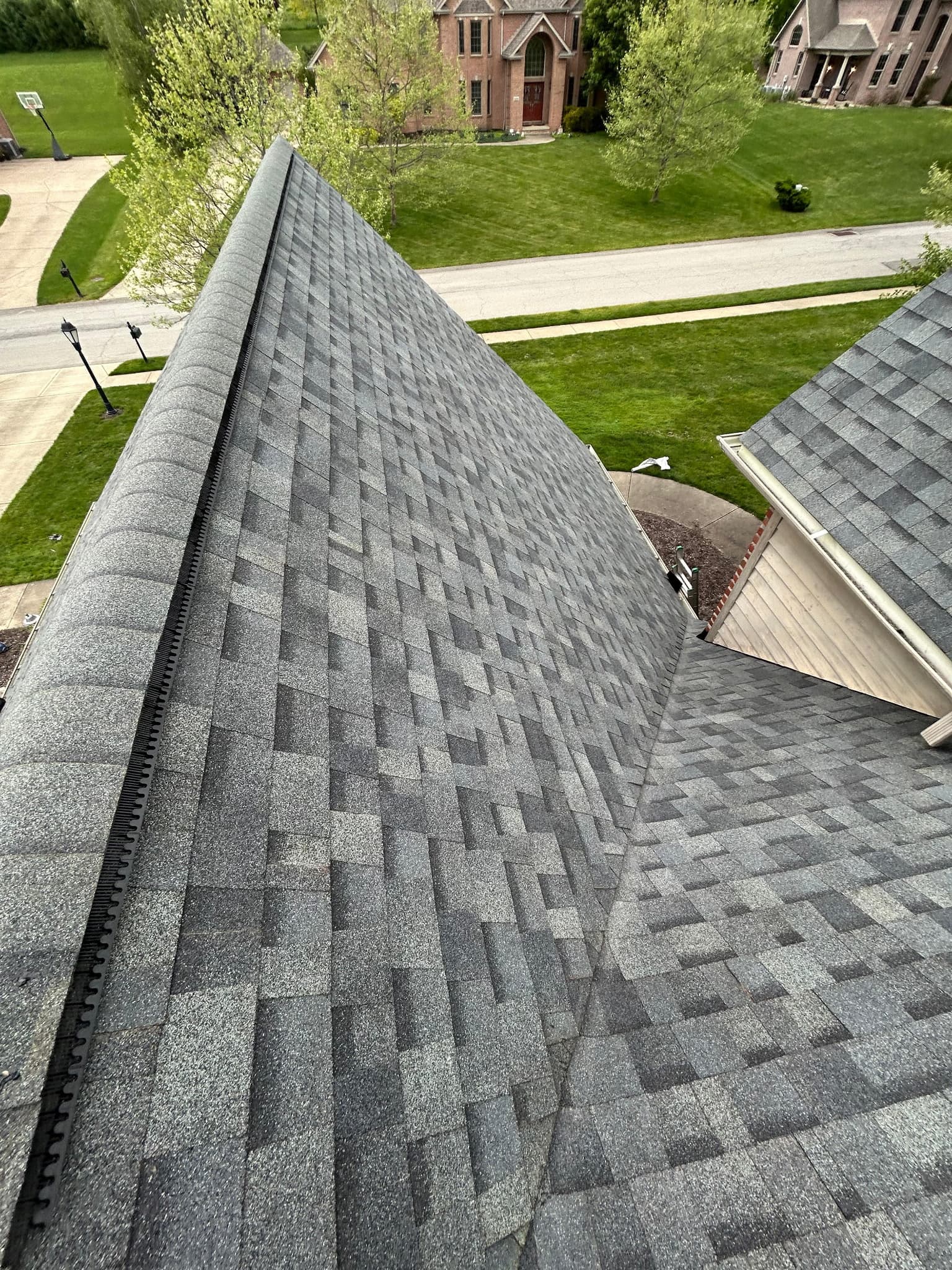 Finished roof ridge with the neighborhood street in view