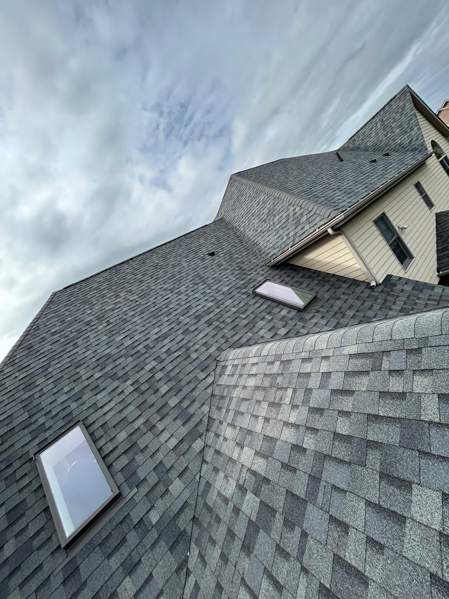 Complex roofline with skylight in fresh architectural shingles