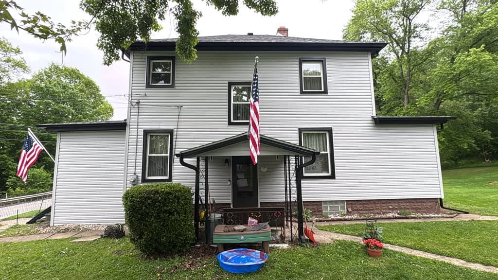 White vinyl siding with black trim, front of a Pittsburgh-area home